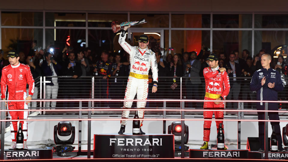 Max Verstappen celebrates his victory at the Las Vegas Grand Prix, while Sergio Perez (right) and Charles Leclerc (left) are on the podium for second and third, respectively.