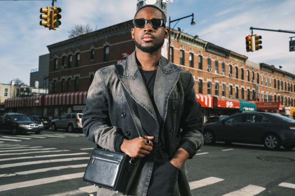 CJ Robinson boasts a growing collection of 30-some bags, taking a liking to the luxe accessory two years ago when his career brought him into the fashion industry. Stephen Yang