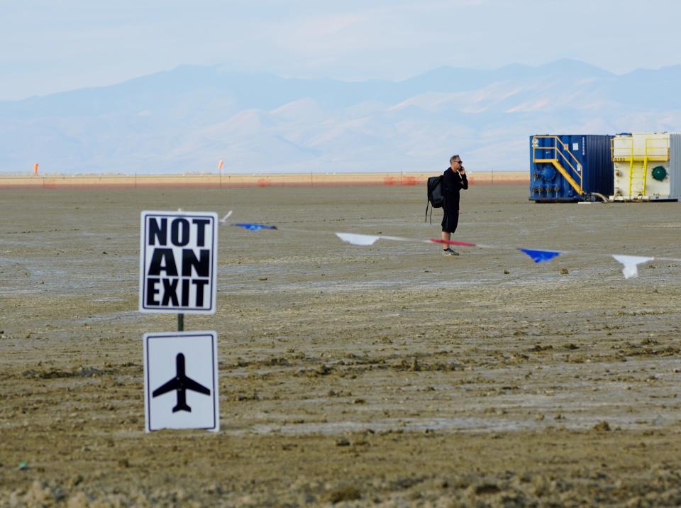 A person talks on a cell phone at Burning Man.