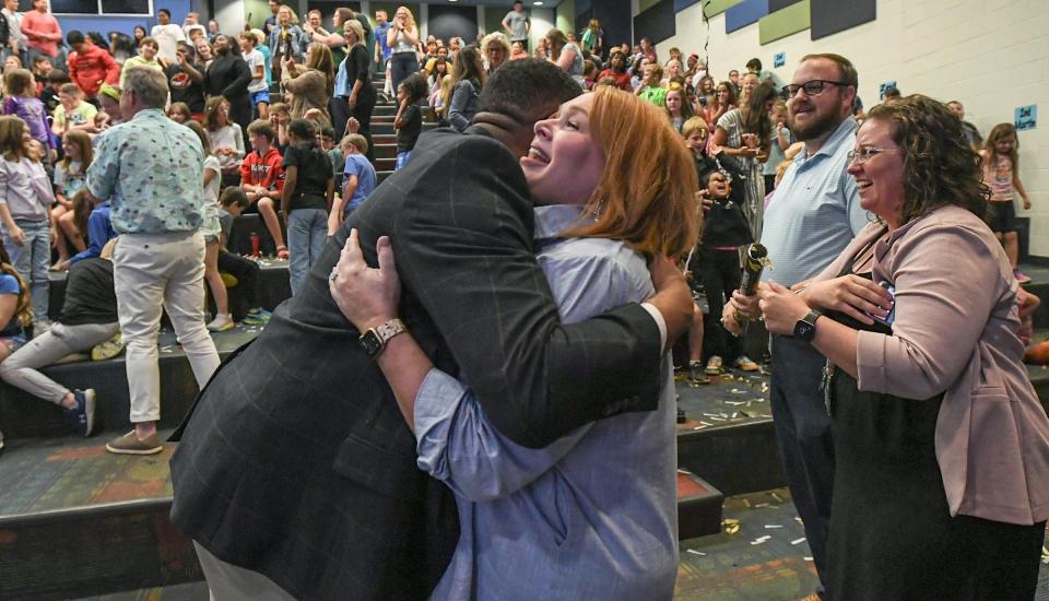 Leonard Galloway, left, of Anderson School District Five, hugs Principal Jill Brackett as faculty and students celebrate as North Pointe Elementary School is named as one of the 2023-24 Palmetto's Finest schools, in the school auditorium in Anderson, S.C. April 23, 2024.