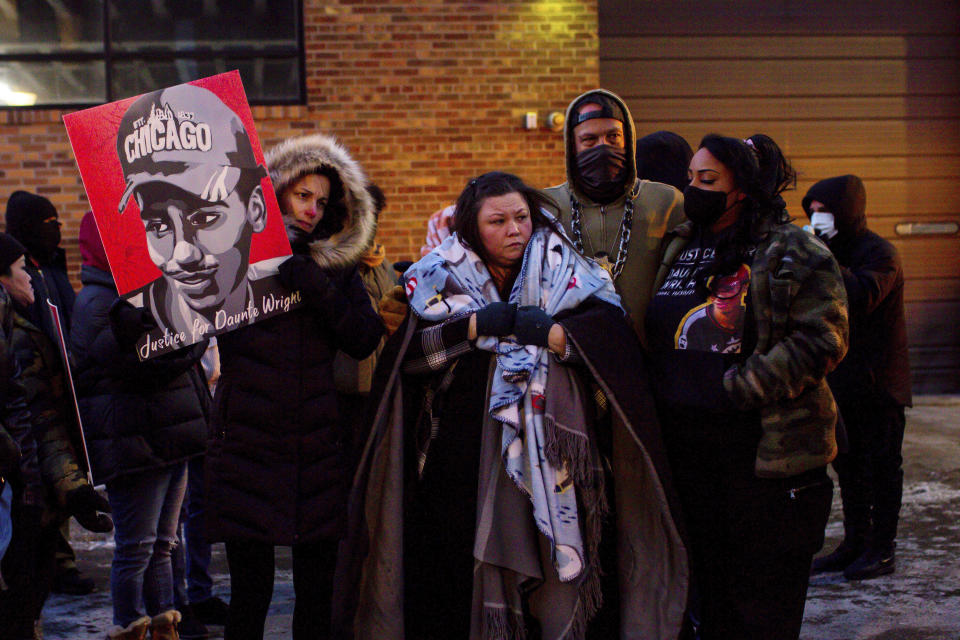 FILE - Katie Bryant, Daunte Wright's mother, is surrounded by community members and activists at the apartment building where activists say Hennepin County Judge Regina Chu lives after former officer Kim Potter was sentenced to two years in prison Friday, Feb. 18, 2022, in Minneapolis. The suburban Minneapolis city has agreed to pay $3.2 million to the family of Daunte Wright, a Black man who was fatally shot by a police officer who said she confused her gun for her Taser. The tentative settlement also includes changes in police policies and training involving traffic stops like the one that resulted in Wright's death, according to a statement Tuesday, June 21, 2022 from attorneys representing Wright's family. (AP Photo/Nicole Neri, File)