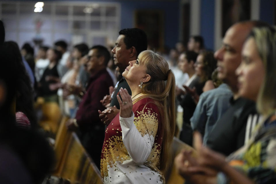 Parishioners pray during Mass at St. Agatha Catholic Church, which has become the spiritual home of the growing Nicaraguan diaspora, Sunday, Nov. 5, 2023, in Miami. For the auxiliary bishop of Managua, his fellow priests and many worshippers who have had to flee or were exiled from Nicaragua recently, the Sunday afternoon Mass at the Miami parish is not only a way to find solace in community, but also to keep pushing back against the Ortega regime's violent suppression of all critics, including many Catholic leaders. (AP Photo/Rebecca Blackwell)