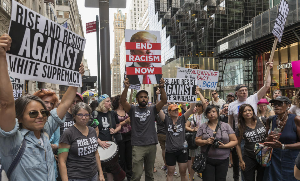 Ahead of President Donald Trump's visit, about 400 demonstrators on Fifth&nbsp;Avenue near Trump Tower in New York attend a rally protesting the violence&nbsp;in Charlottesville.