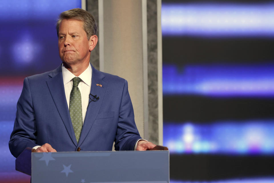 Georgia Gov. Brian Kemp reacts as he tries to ignore an answer from former Sen. David Perdue during a Republican gubernatorial debate, Sunday, April 24, 2022, in Atlanta. (Miguel Martinez/Atlanta Journal-Constitution via AP)