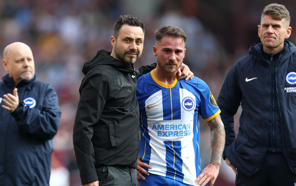 Roberto De Zerbi, Manager of Brighton & Hove Albion, comforts Alexis Mac Allister after the final whistle of the Premier League match between Aston Villa and Brighton & Hove Albion at Villa Park on May 28, 2023 in Birmingham, England.