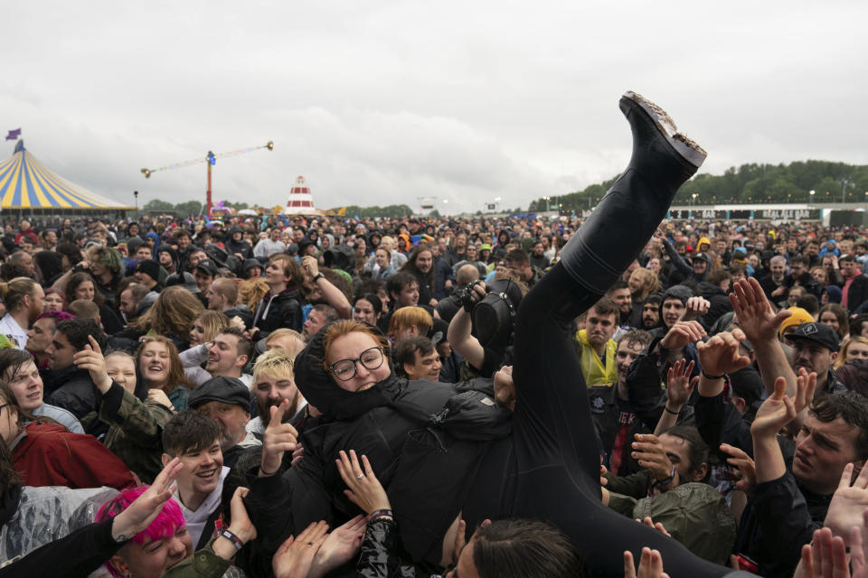 A festivalgoer crowd surfs on the first day of Download Festival at Donington Park at Castle Donington, England, Friday June 18, 2021. The three-day music and arts festival is being held as a test event to examine how Covid-19 transmission takes place in crowds, with the the capacity significantly reduced from the normal numbers. (Joe Giddens/( /PA via AP)