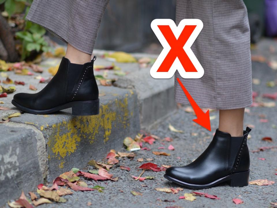 red x and arrowing pointing at someone walking down the street wearing black ankle boots and slacks