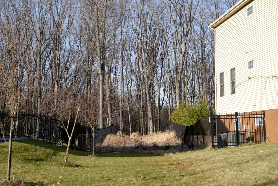 The site of a proposed driveway off of Bartram Road on Tuesday, March 12, 2024 in Marlboro, New Jersey. Fence to fence, it is 25 feet wide.