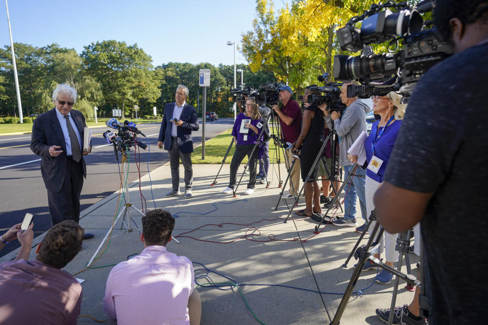 Nancy Mark's attorney Ray Perini, left, speaks to reporters outside federal court, Thursday, Oct. 5, 2023, in Central Islip, N.Y. Marks, the ex-campaign treasurer for U.S. Rep. George Santos pleaded guilty Thursday to conspiring to defraud the U.S. government and implicated the indicted New York Republican in court with submitting bogus campaign finance reports. (AP Photo/Mary Altaffer)