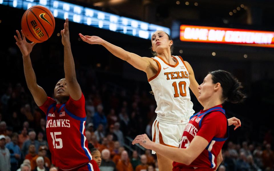 Texas Longhorns guard Shay Holle (10) reaches over to scoop the ball from Kansas Jayhawks guard Zakiyah Franklin (15) the the Longhorns in the first half of their game against the Kansas Jayhawks at the Moody Center in Austin, Jan 16, 2024. Texas won the game 91-56.