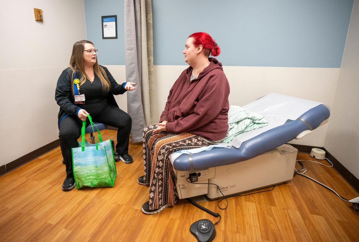 Community Health Worker Mariah Sharpe, left, speaks with Mariah Snyder about postpartum care during her appointment at the OhioHealth Castrop Health Center in Athens, Ohio. Community health workers like Sharpe are pointed to as part of what could help improve access to health care in rural areas of the nation.