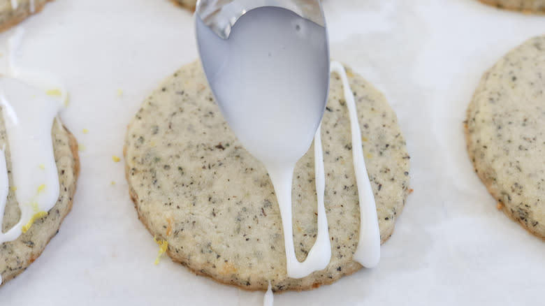 glaze being drizzed on lemon-glazed Earl Grey cookies