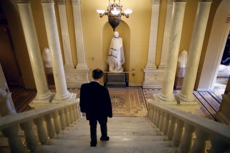 A reporter walks down the stairs outside the Senate Chamber at the U.S. Capitol in Washington, January 20, 2016. REUTERS/Carlos Barria