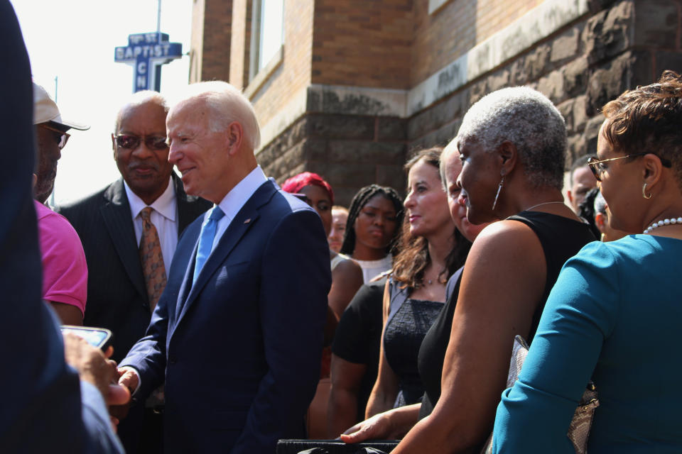 Former Vice President and presidential candidate Joe Biden, center, left, speaks with an attendee as he joins Sen. Doug Jones and Birmingham Mayor Randall Woodfin at a wreath laying after a service at 16th Street Baptist Church in Birmingham, Ala., Sunday, Sept. 15, 2019. Visiting the black church bombed by the Ku Klux Klan in the civil rights era, Democratic presidential candidate Biden said Sunday the country hasn't "relegated racism and white supremacy to the pages of history" as he framed current tensions in the context of the movement's historic struggle for equality. (Ivana Hrynkiw/The Birmingham News via AP)