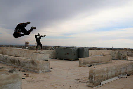 Parkour coach Ibrahim al-Kadiri, 19, demonstrates his Parkour skills with his friend in the rebel-held city of Inkhil, west of Deraa, Syria, February 4, 2017. Ibrahim says many team members suffered injuries, including broken toes and bruises. He himself injured his back: "Eight months ago, during an attempt to jump from high place, I injured my back and I stayed in bed for several days until I recovered." REUTERS/Alaa Al-Faqir