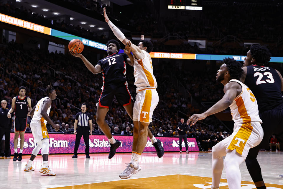 Georgia forward Matthew-Alexander Moncrieffe (12) shoots next to Tennessee forward Olivier Nkamhoua during the first half of an NCAA college basketball game Wednesday, Jan. 25, 2023, in Knoxville, Tenn. (AP Photo/Wade Payne)