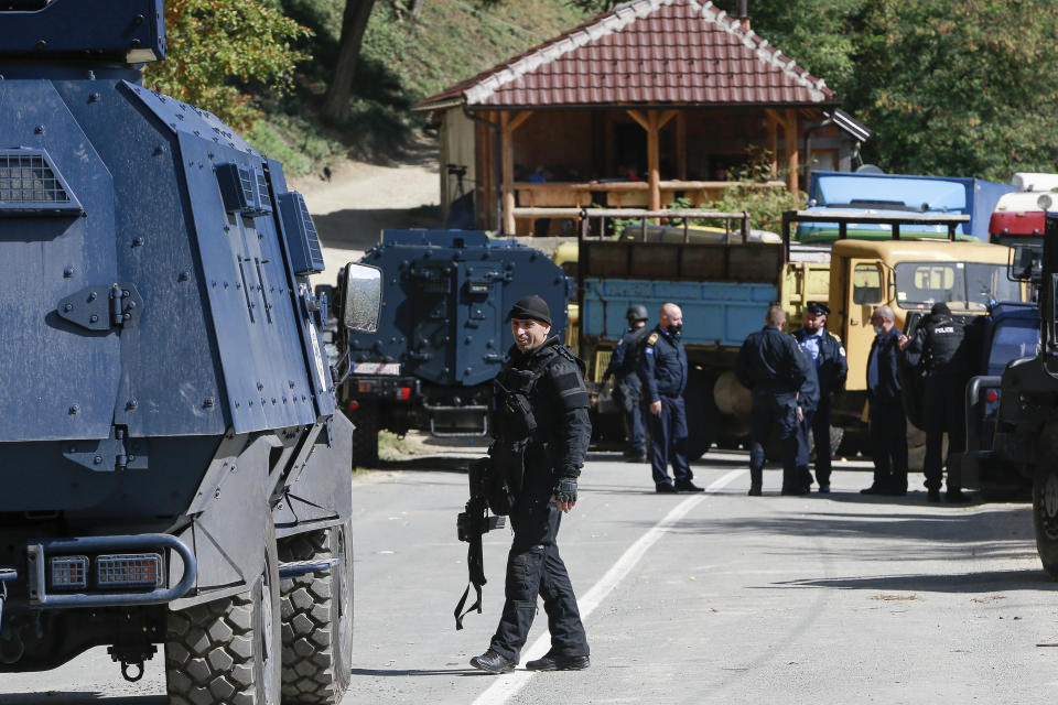 Kosovo police officers secure the area at the barricades placed by local Serbs near the northern Kosovo border crossing of Brnjak on the fifth day of protest on Friday, Sept. 24, 2021. Ethnic Serbs in Kosovo have been blocking the border for a fifth straight day to protest a decision by Kosovo authorities to start removing Serbian license plates from cars entering the country, raising fears such incidents could unleash much deeper tensions between the two Balkan foes.(AP Photo/Visar Kryeziu)