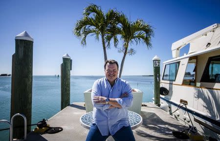 Former Air Force C-130 pilot, Brian Hall, a businessman who wants to start 4-hour round trip service between Marathon in the Florida Keys and Havana, poses for or a picture in the the Marathon Marina in Marathon, Florida February 20, 2015. REUTERS/Mark Blinch