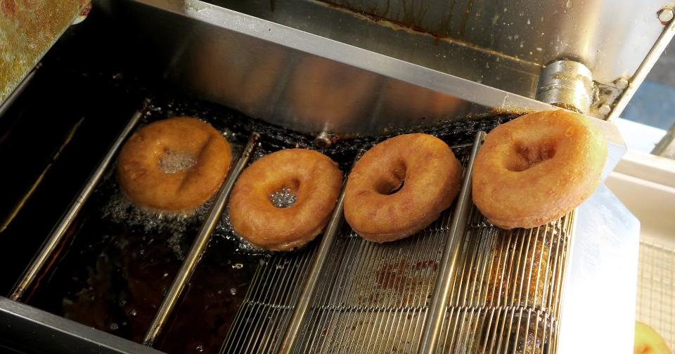 Fresh donuts are prepared at Top That! Donuts at the Point Pleasant Beach shop Thursday, May 26, 2022.   The business is run by husband and wife team Danielle and Chris Wolowitz.