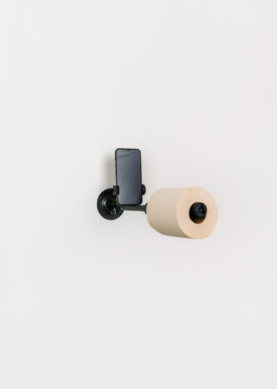 A toilet paper holder design by WeShouldDoItAll includes a cellphone holder.