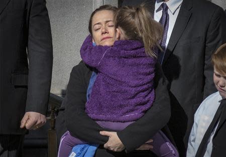 Mimi O'Donnell, former partner of actor Phillip Seymour Hoffman, holds their daughter Willa as the casket arrives for the funeral of actor Hoffman in the Manhattan borough of New York, February 7, 2014. REUTERS/Brendan McDermid