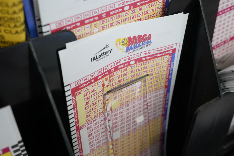 Blank forms for the Mega Millions lottery sit in a bin at a local grocery store, Tuesday, Jan. 12, 2021, in Des Moines, Iowa. Lottery players have a chance to win the largest jackpots in nearly two years as Tuesday's Mega Millions has grown to an estimated $625 million and Wednesday's Powerball to an estimated $550 million. (AP Photo/Charlie Neibergall)