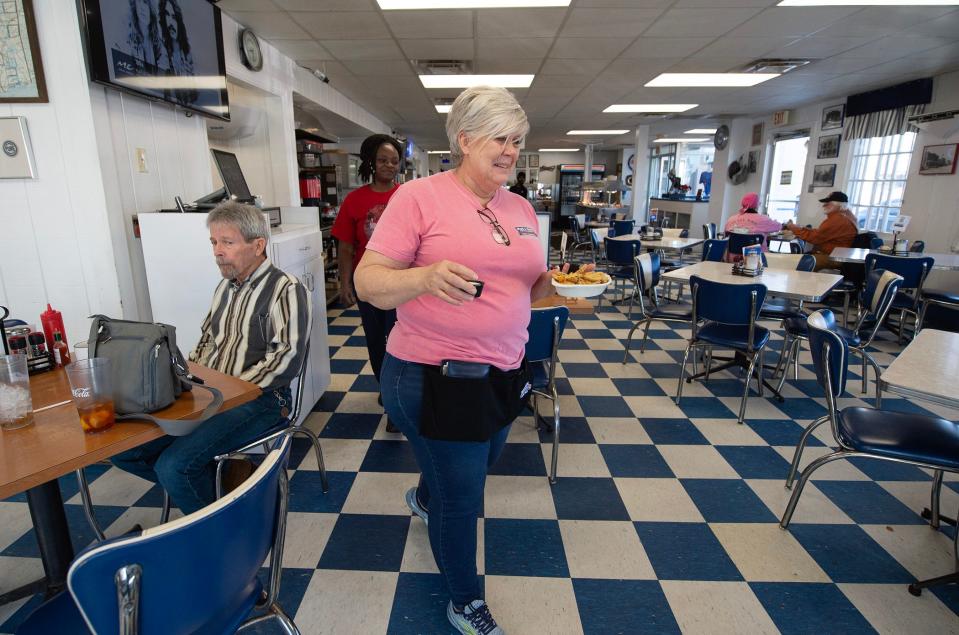Waitress Tanjua Spencer of Tunica, Miss., has worked at the Blue and White Restaurant in Tunica on and off for 40 years. At times, her mother, grandmother and sister have also worked at the Blue and White. The restaurant is celebrating its 100th year in business this year.