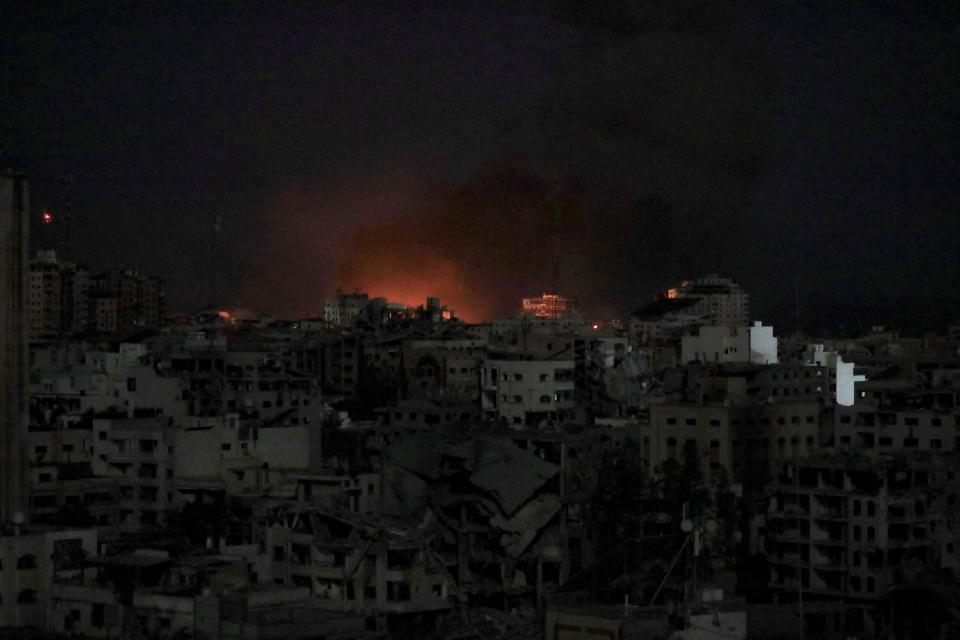Flames rise during an Israeli air strike on west Gaza, 30 October 2023 (Reuters)