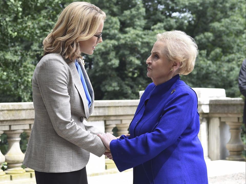 tea leoni and madeleine albright hold hands and look at each other on the show madam secretary