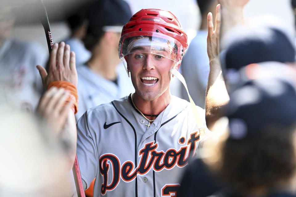 Detroit Tigers' Kerry Carpenter celebrates with teammates after hitting a solo home run off Cleveland Guardians relief pitcher Enyel De Los Santos during the seventh inning of a baseball game, Sunday, Aug. 20, 2023, in Cleveland. (AP Photo/Nick Cammett)