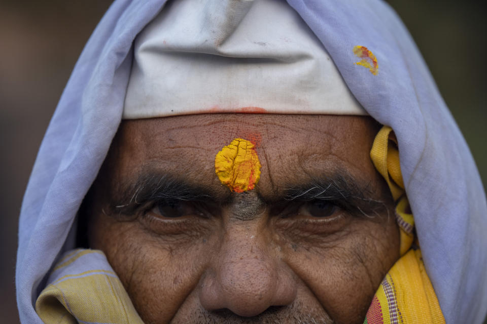 An Indian pilgrim who is embarked on a visit to the sacred Pashupatinath temple poses for a photograph in Kathmandu, Nepal, Jan. 12, 2024. The centuries-old temple is one of the most important pilgrimage sites in Asia for Hindus.Nepal and India are the world’s two Hindu-majority nations and share a strong religious affinity. Every year, millions of Nepalese and Indians visit Hindu shrines in both countries to pray for success and the well-being of their loved ones. (AP Photo/Niranjan Shrestha)