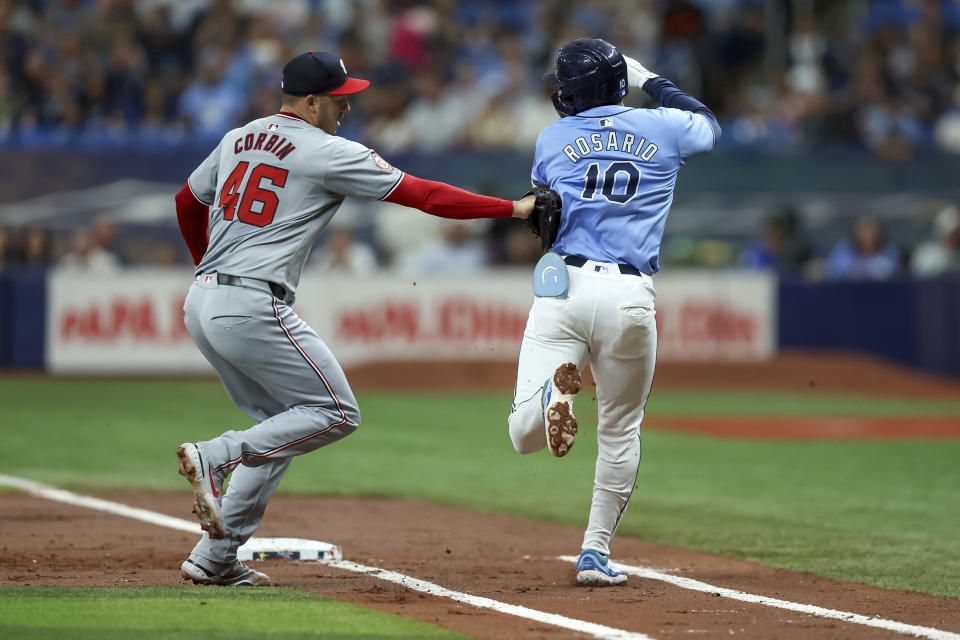 Washington Nationals starting pitcher Patrick Corbin, left, tags out Tampa Bay Rays' Amed Rosario on a ground ball during the first inning of a baseball game, Sunday, June 30, 2024, in St. Petersburg, Fla. (AP Photo/Mike Carlson)