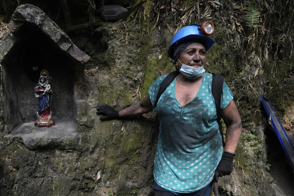 Maria Julia Pena, 66, stands outside an informal mine near the town of Coscuez, Colombia, Wednesday, Feb. 28, 2024. To enter the small mines around Coscuez, women wear rubber boots and helmets and carry drills just like the men. (AP Photo/Fernando Vergara)