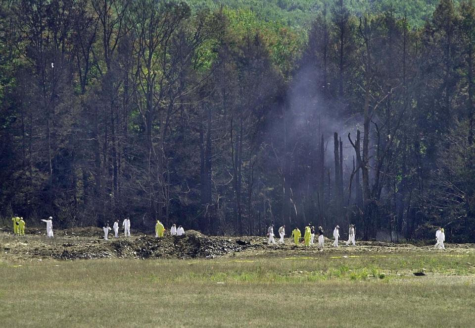 In this file photo investigative personnel search the crash site of United Airlines Flight 93 looking for debris and evidence, including the plane's flight recorder, in Shanksville, Pennsylvania on September 12, 2001.