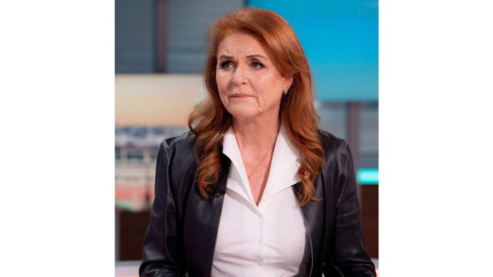 Sarah Ferguson looking sad in a white shirt and leather jacket