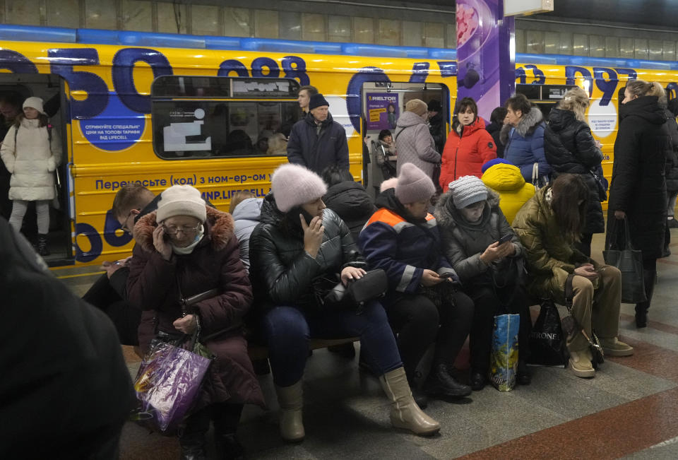 People rest in the subway station, being used as a bomb shelter during a rocket attack in Kyiv, Ukraine, Friday, Dec. 16, 2022. Ukrainian authorities reported explosions in at least three cities Friday, saying Russia has launched a major missile attack on energy facilities and infrastructure. Kyiv Mayor Vitali Klitschko reported explosions in at least four districts, urging residents to go to shelters. (AP Photo/Efrem Lukatsky)