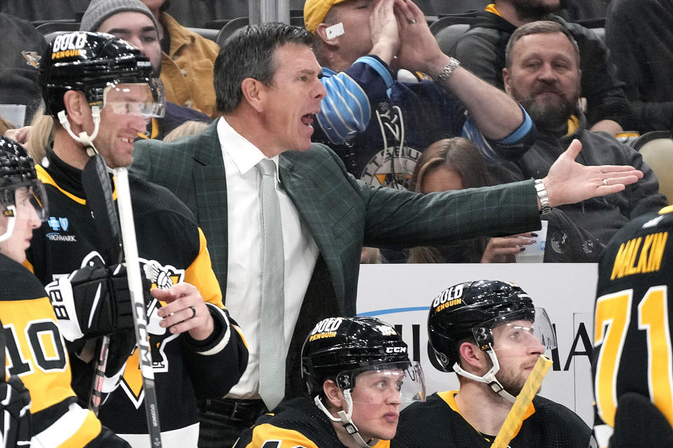 Pittsburgh Penguins coach Mike Sullivan, center, disagrees with a call during the second period of the team's NHL hockey game against the Florida Panthers in Pittsburgh, Friday, Jan. 26, 2024. (AP Photo/Gene J. Puskar)