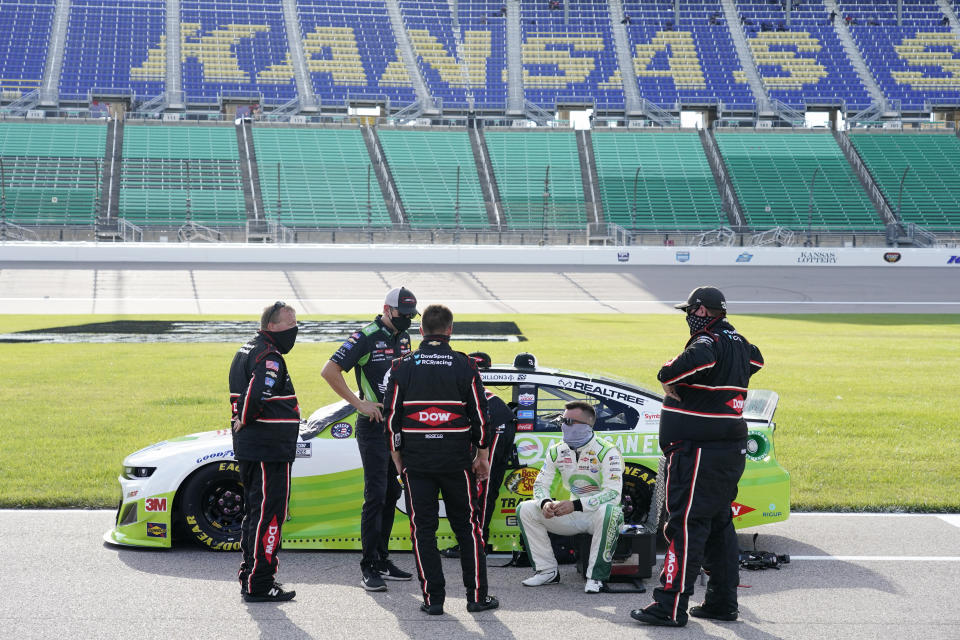 Driver Austin Dillon, second from right, talks with his crew before a NASCAR Cup Series auto race at Kansas Speedway in Kansas City, Kan., Thursday, July 23, 2020. (AP Photo/Charlie Riedel)