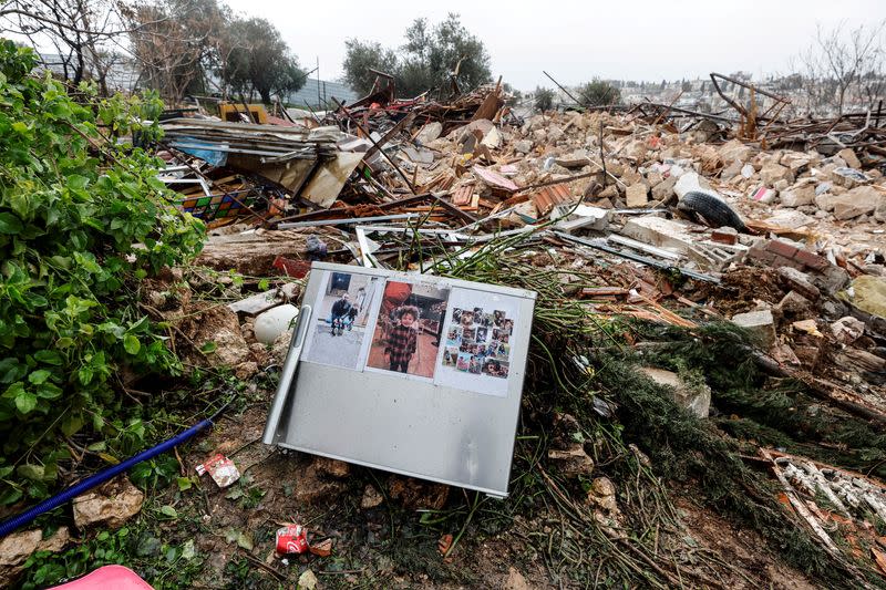 FILE PHOTO: Family photos are seen on the remains of a refrigerator at the site of a demolished house in the Sheikh Jarrah neighbourhood of East Jerusalem