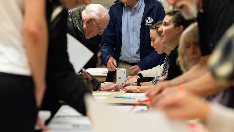 Attendees check in at a Republican caucus at Centennial Middle School in Provo on Tuesday, March 5, 2024.