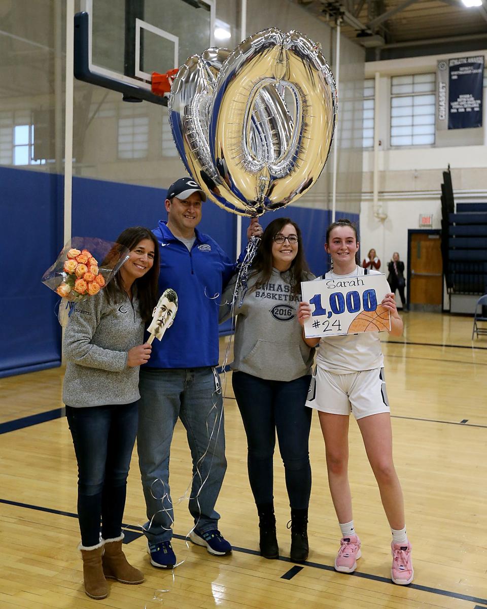 Sarah Chenette gets a photo with her family after scoring her 1000th point in the second quarter of their game against Monument Mountain in the Round of 32 game in the Division 4 state tournament at Cohasset High on Friday, March 3, 2023.