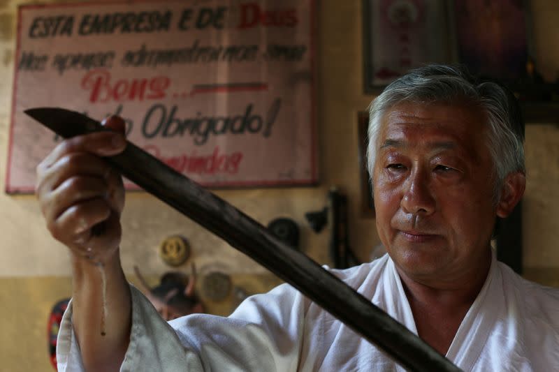 Samurai Suemitsu shows a katana sword at his home in Curitiba