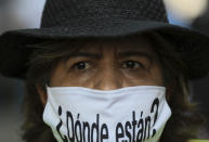 A person wears a mask with the Spanish question: "Where are they?" during a march in remembrance of those who have disappeared, on Mother's Day in Mexico City, Monday, May 10, 2021. (AP Photo/Fernando Llano)