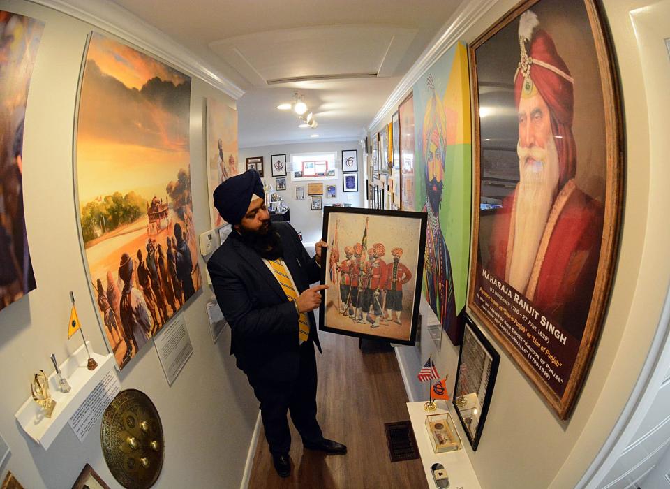 Swaranjit Singh Khalsa, creative director of Sikh Art Gallery shows a World War I Sikh soldiers piece at his Norwich gallery. File photo