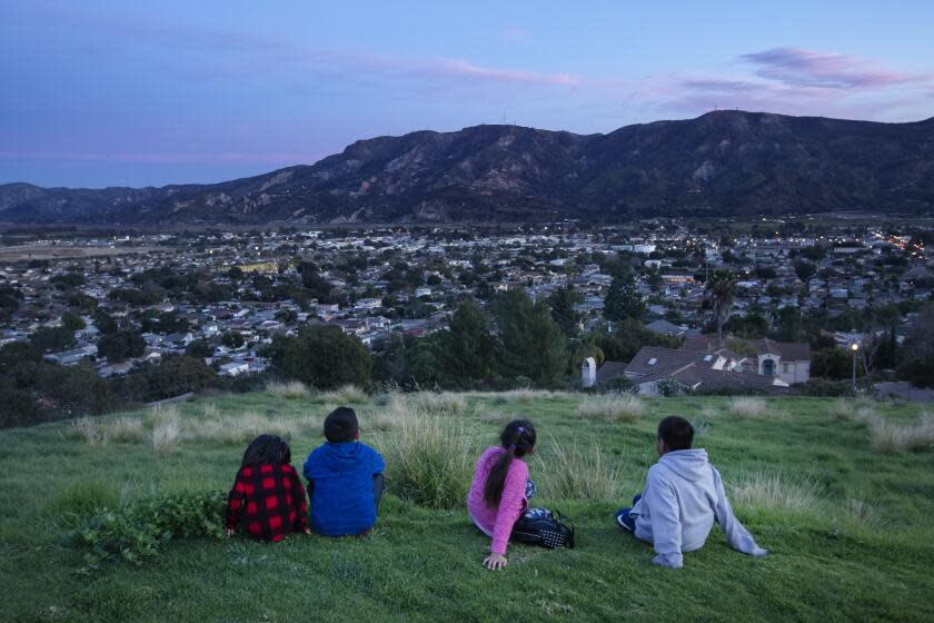 SANTA PAULA, CA-JANUARY 29, 2020: left to right-Celestea Rojas, her cousin George Valencia, cousin Concepcion Valencia, and friend Moises Tomas take in the view of Santa Paula from above. (Mel Melcon/Los Angeles Times)