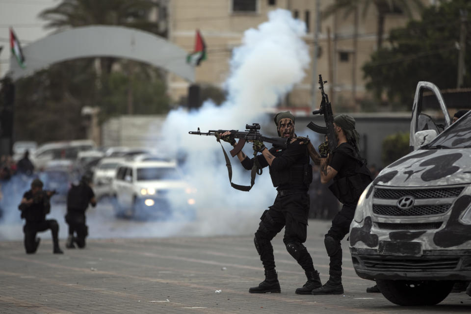 Members of the Palestinian security forces loyal to Hamas display their skills during a graduation ceremony in Gaza City, Sunday, Dec. 12, 2021. Gaza’s Hamas rulers collect millions of dollars a month in taxes and customs at a crossing on the Egyptian border – providing a valuable source of income that helps it sustain a government and powerful armed wing. After surviving four wars and a nearly 15-year blockade, Hamas has become more resilient and Israel has been forced to accept that its sworn enemy is here to stay. (AP Photo/ Khalil Hamra)