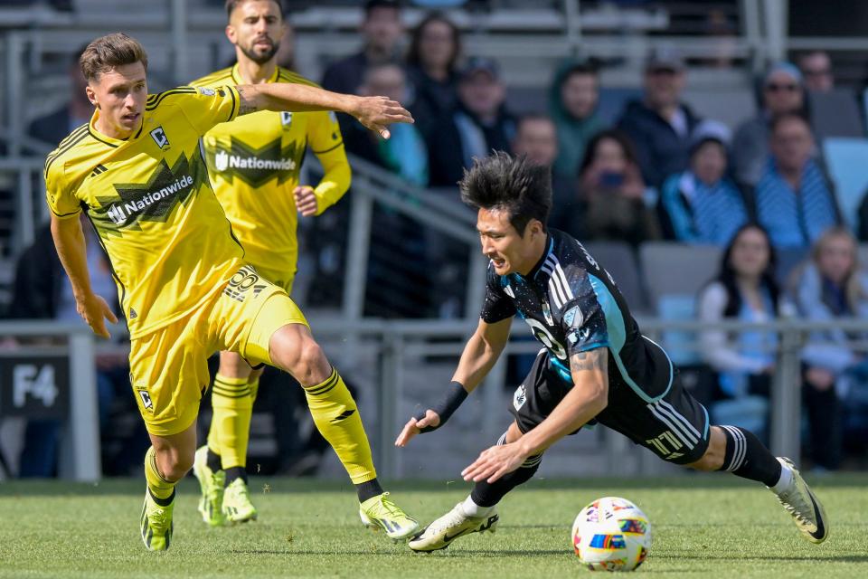 Crew defender Malte Amundsen and Minnesota's Sang Bin Jeong chase after the ball on Saturday.