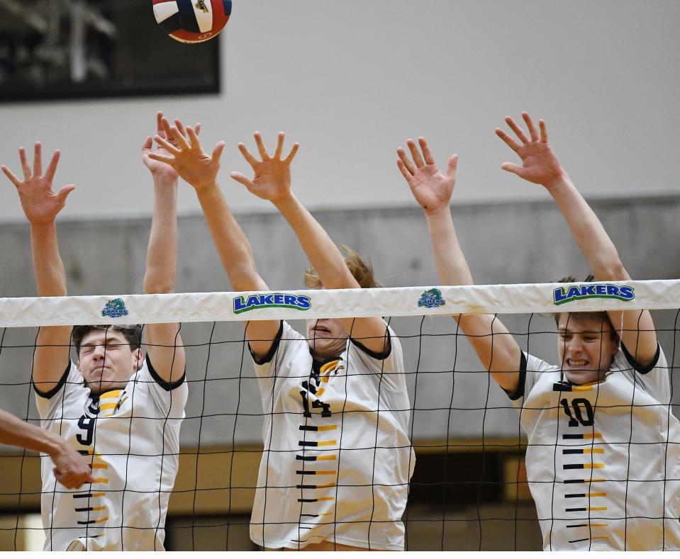 Sean Baird, Collin Auburn and Brody Jackson of Spencerport go for the block attempt on Saturday.