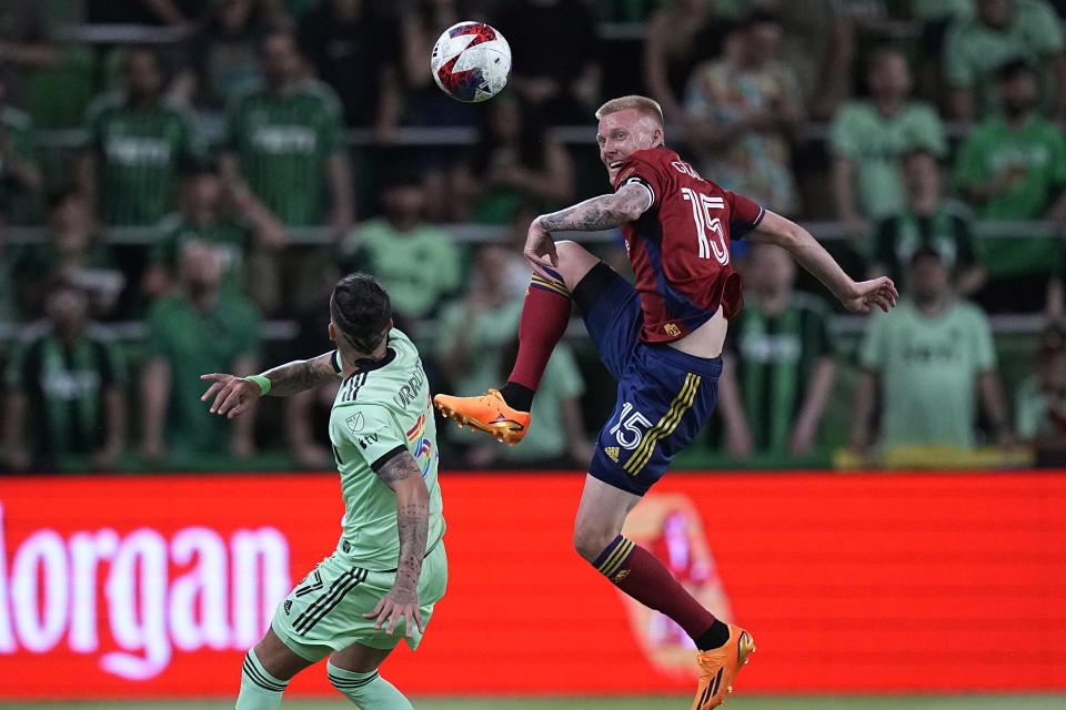 Real Salt Lake defender Justen Glad (15) passes the ball over Austin FC forward Maximiliano Urruti during the second half of an MLS soccer match in Austin, Texas, Saturday, June 3, 2023. (AP Photo/Eric Gay)