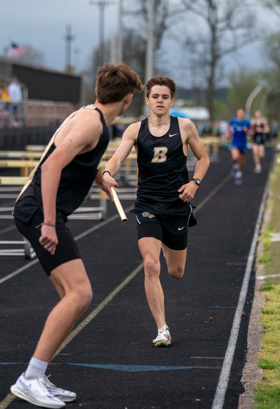 Boonville’s Eli Mayes hands off in the 4x800 meter relay during a track meet in Boonville, Ind., Tuesday, April 9, 2024.